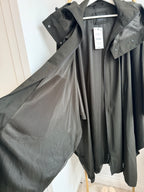     Close-up of Zara khaki cape rain coat showing loose cape-style shape