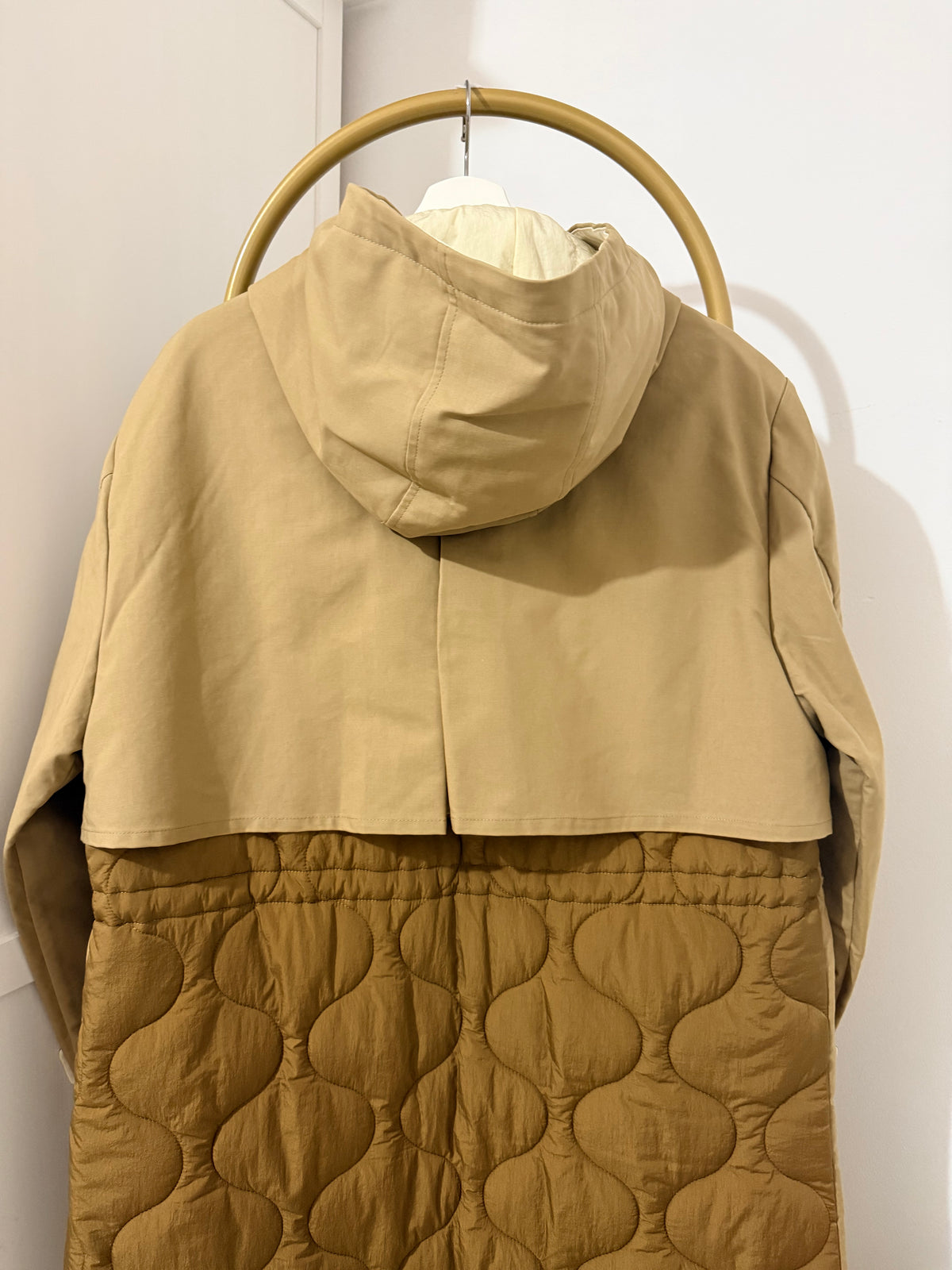     Back detail of Zara beige padded hooded trench coat