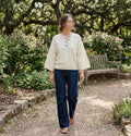     Woman wearing Zara cream wide sleeve knit jumper with dark jeans outdoors