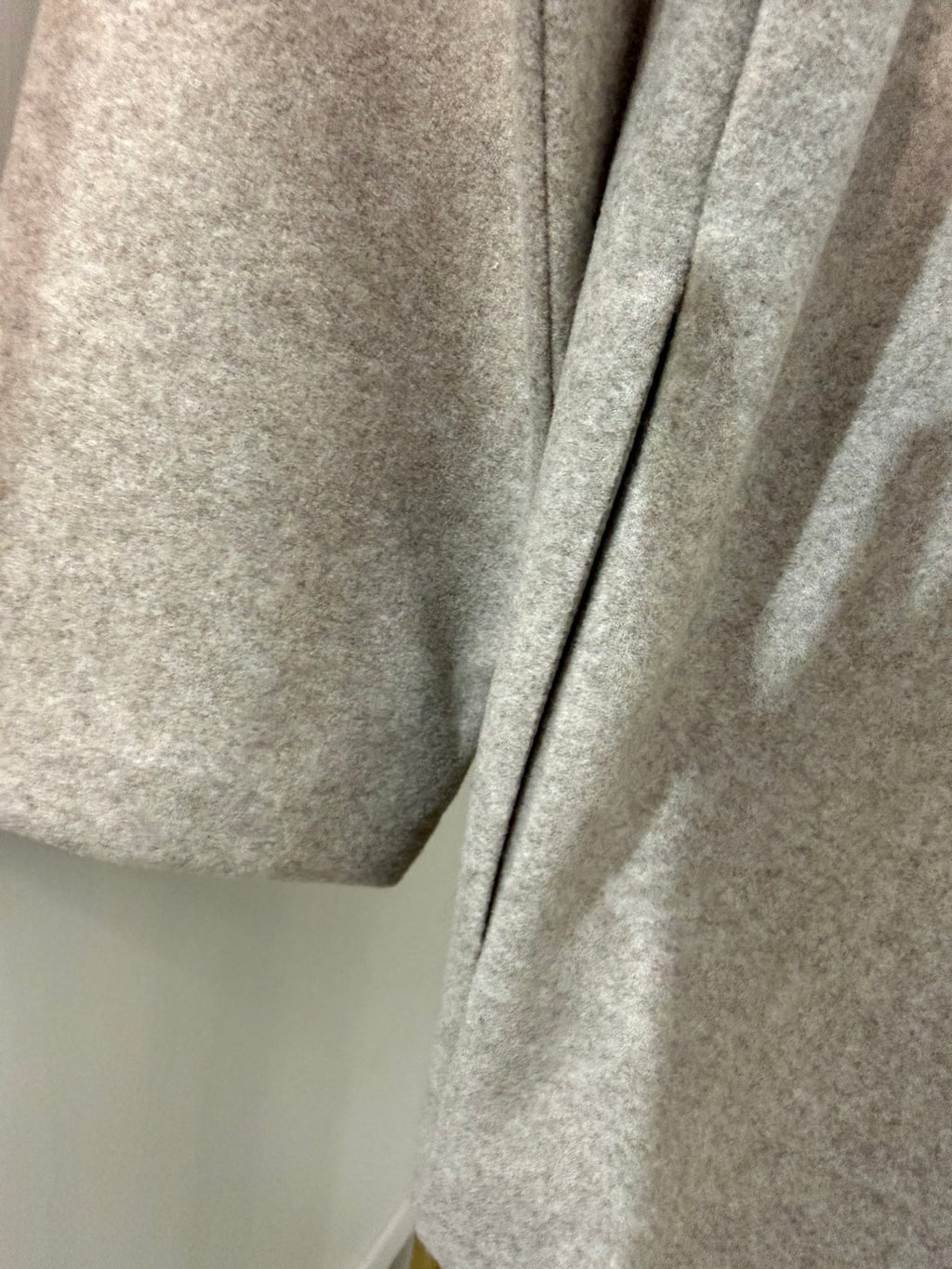         Close-up of pocket detail on Zara beige oversized coat
