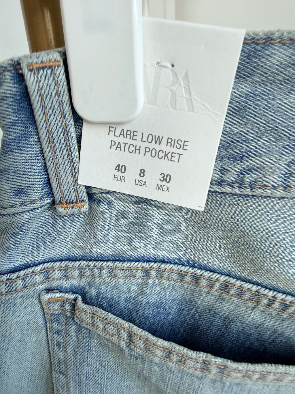     Close-up of Zara jeans label and blue denim fabric