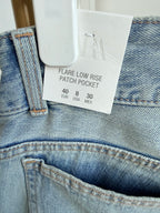     Close-up of Zara jeans label and blue denim fabric