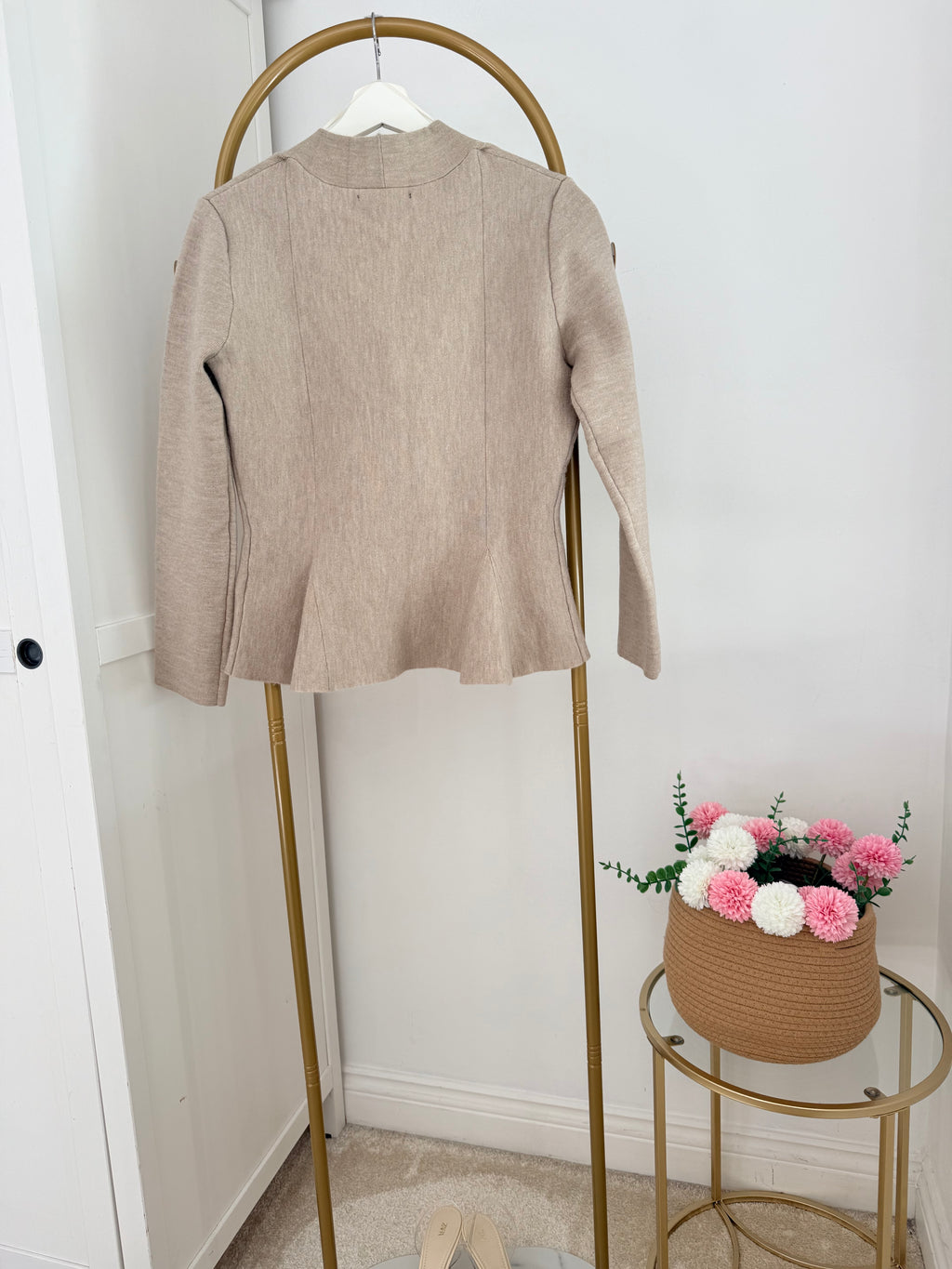     Back view of Zara beige knit peplum cardigan on hanger