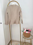     Back view of Zara beige knit peplum cardigan on hanger