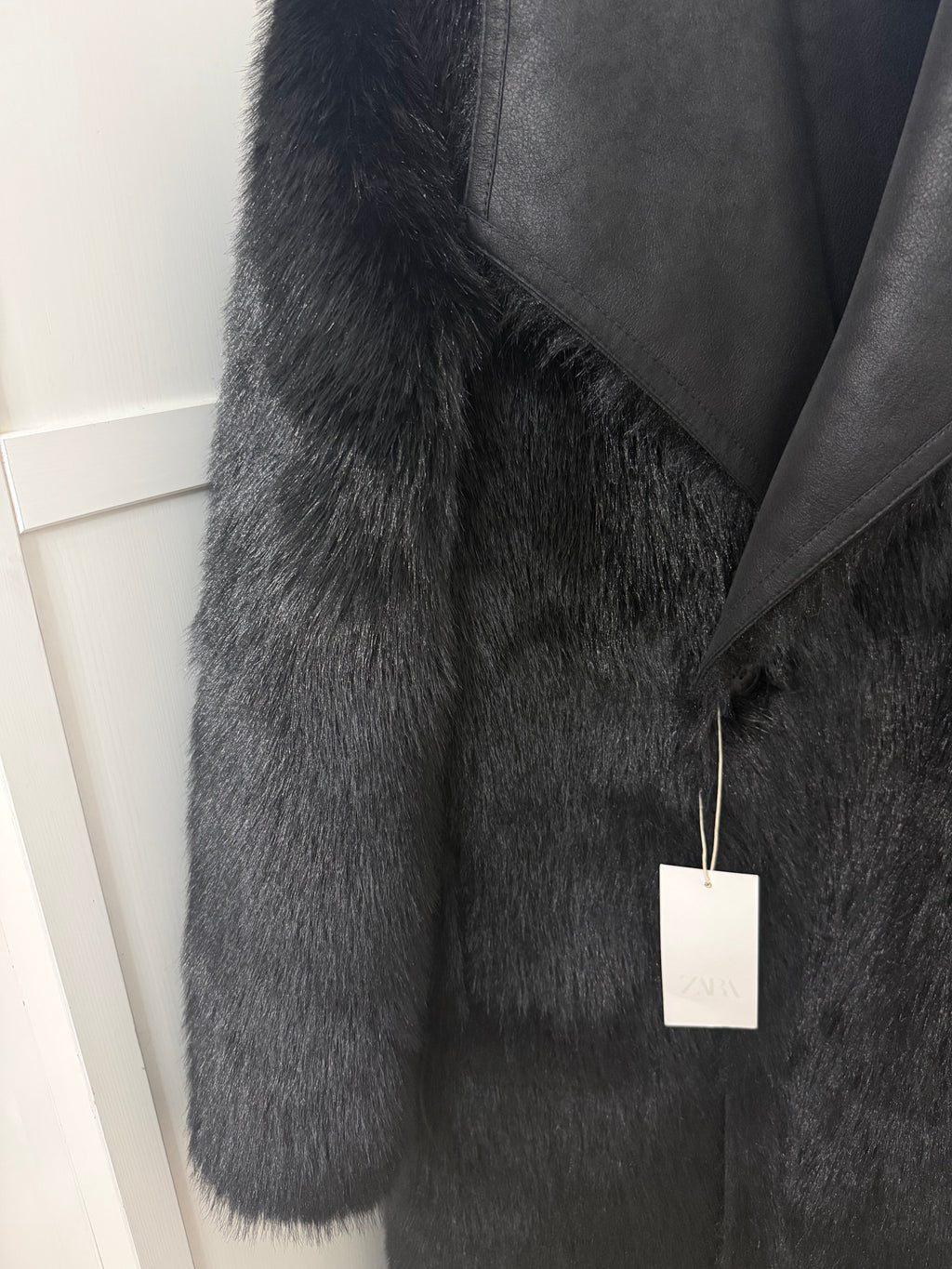     Close-up of Zara black faux fur coat collar and front