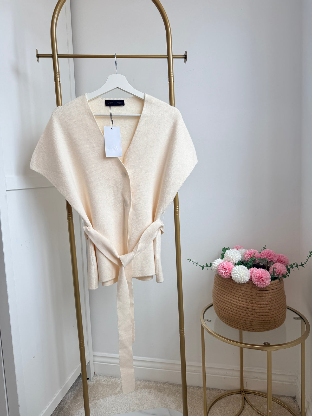     Front view of Zara cream knit belted waistcoat on hanger