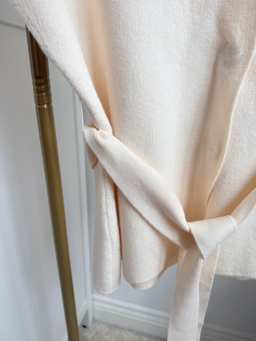     Close-up of matching tie belt on Zara cream knit waistcoat