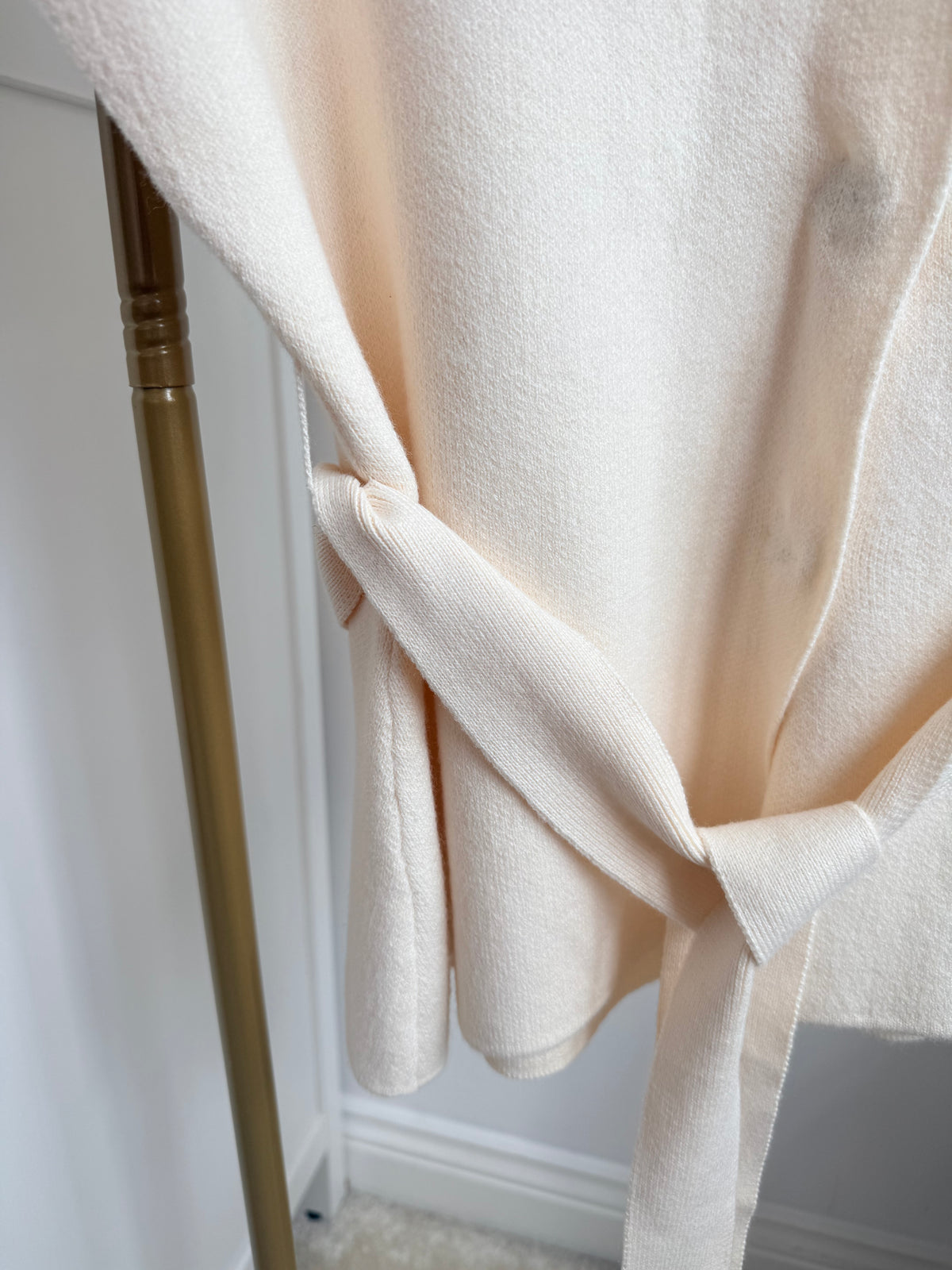     Close-up of matching tie belt on Zara cream knit waistcoat
