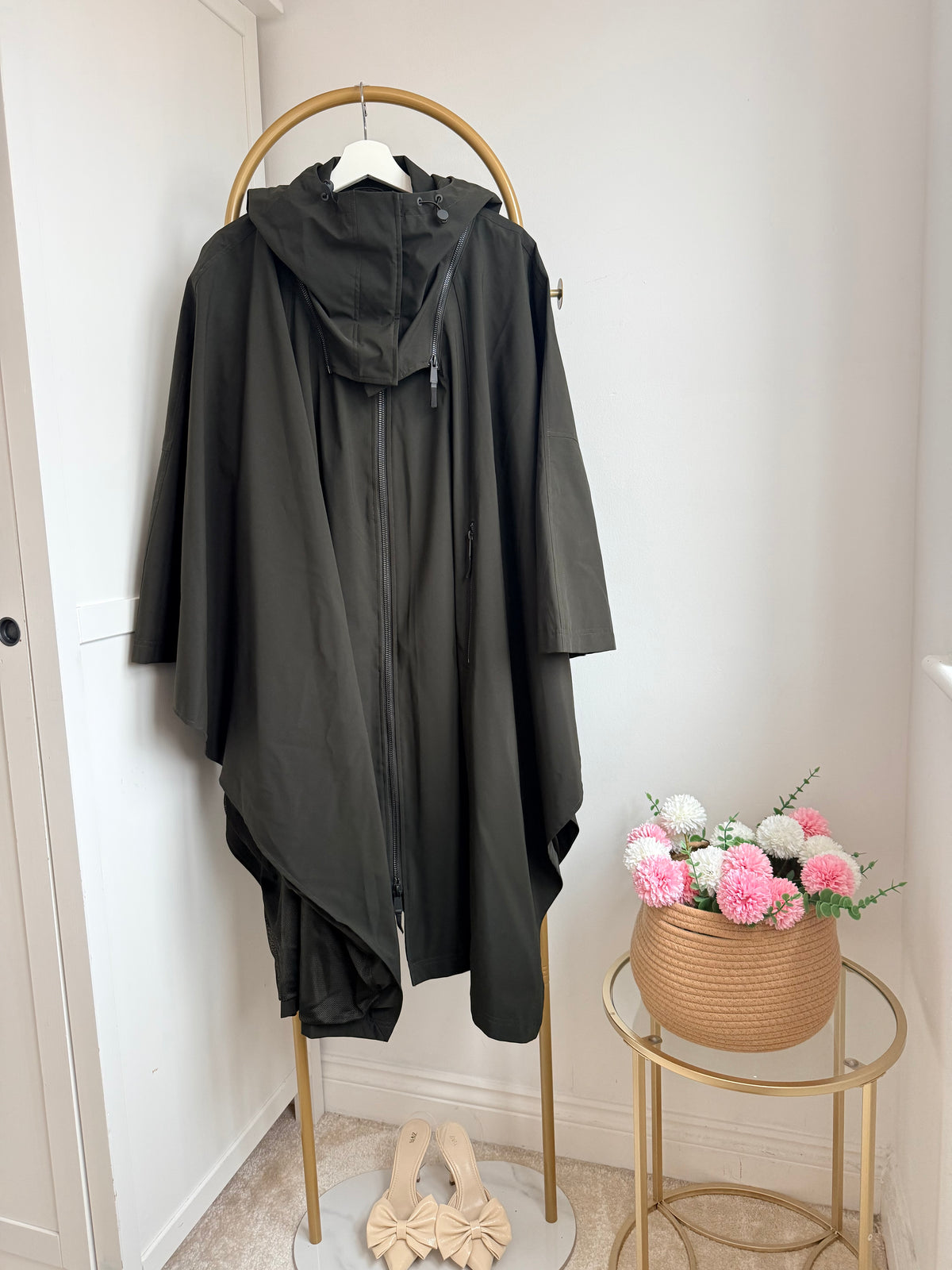     Back view of Zara khaki hooded cape rain coat on hanger