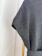     Close-up of grey knit fabric and sleeve detail