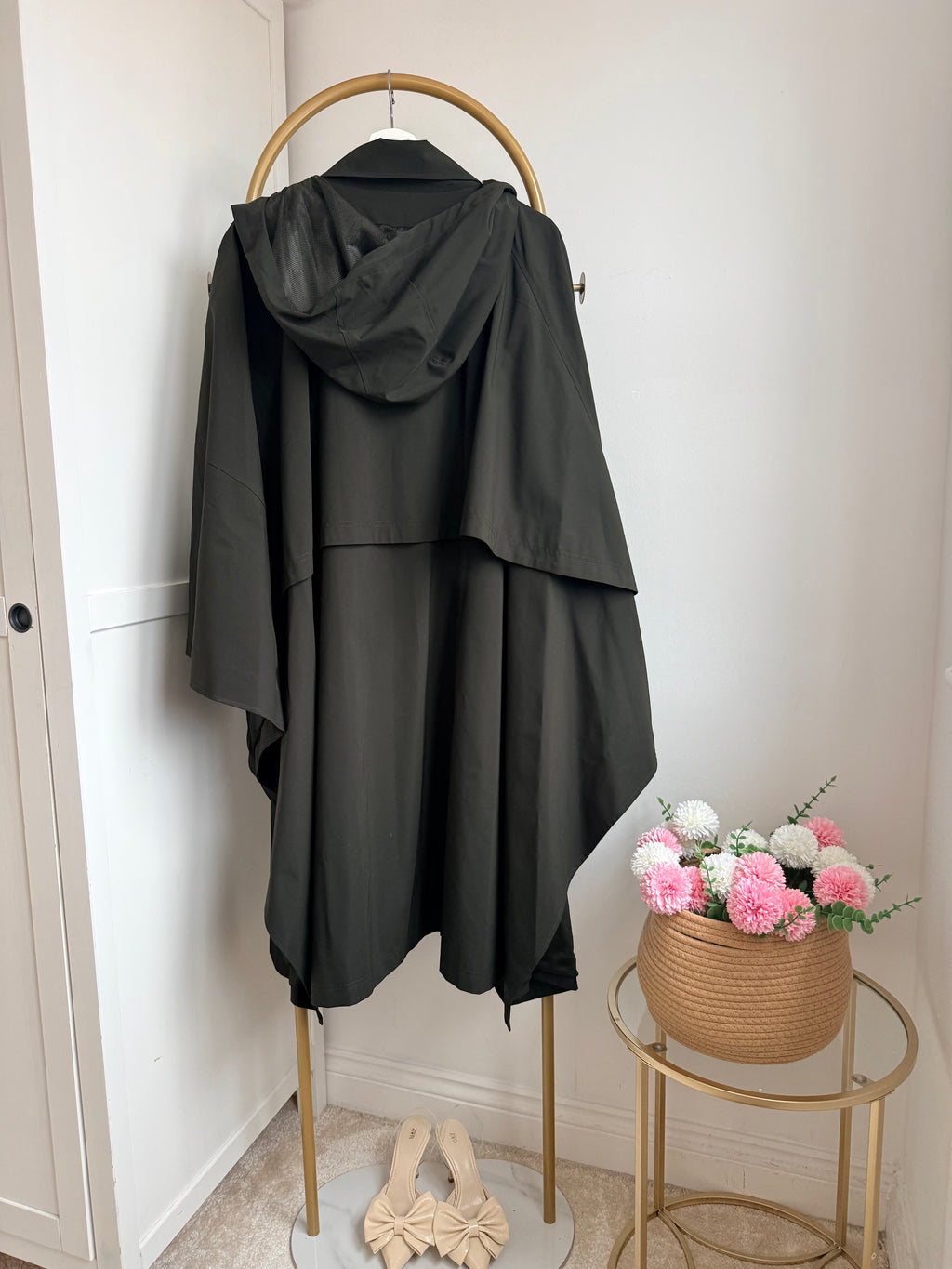     Side view of Zara khaki asymmetric cape rain coat on hanger