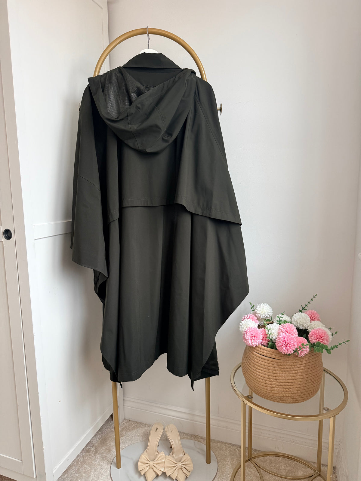     Side view of Zara khaki asymmetric cape rain coat on hanger