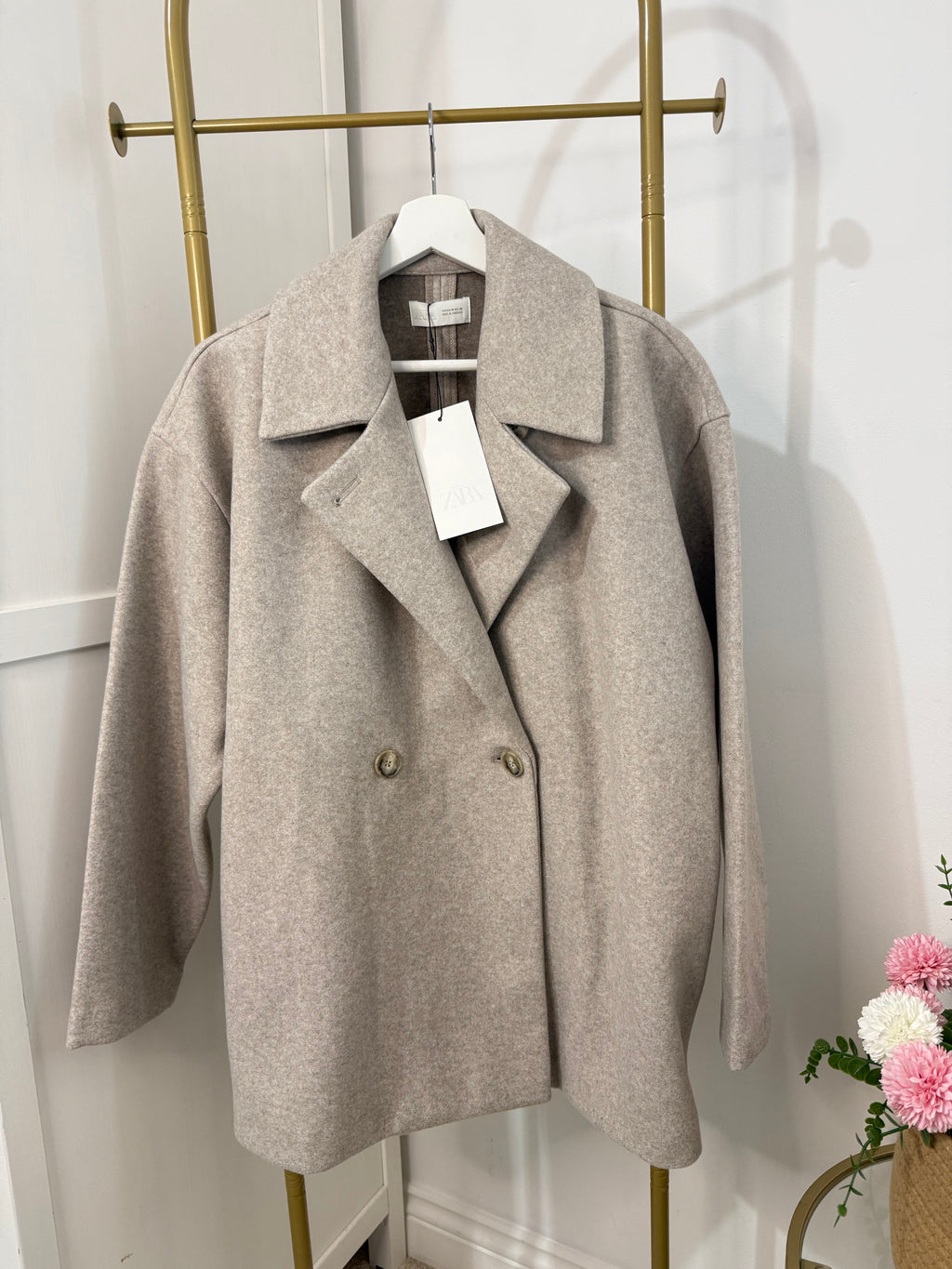     Front view of Zara beige oversized coat on hanger