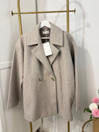     Front view of Zara beige oversized coat on hanger