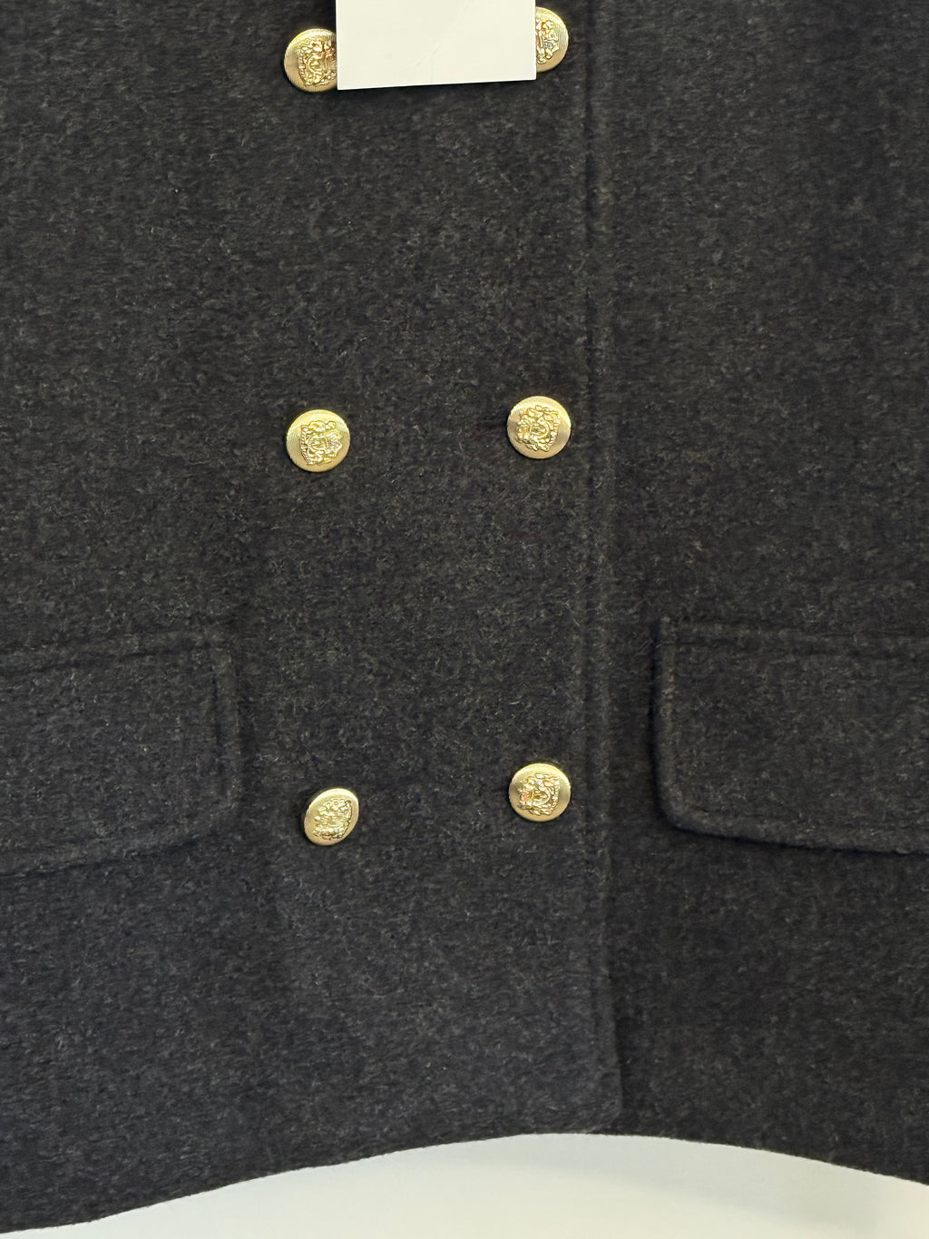     Detail: Close-up of gold buttons and pockets on Zara grey jacket