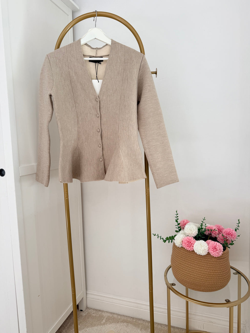     Front view of Zara beige knit peplum cardigan on hanger