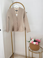     Front view of Zara beige knit peplum cardigan on hanger