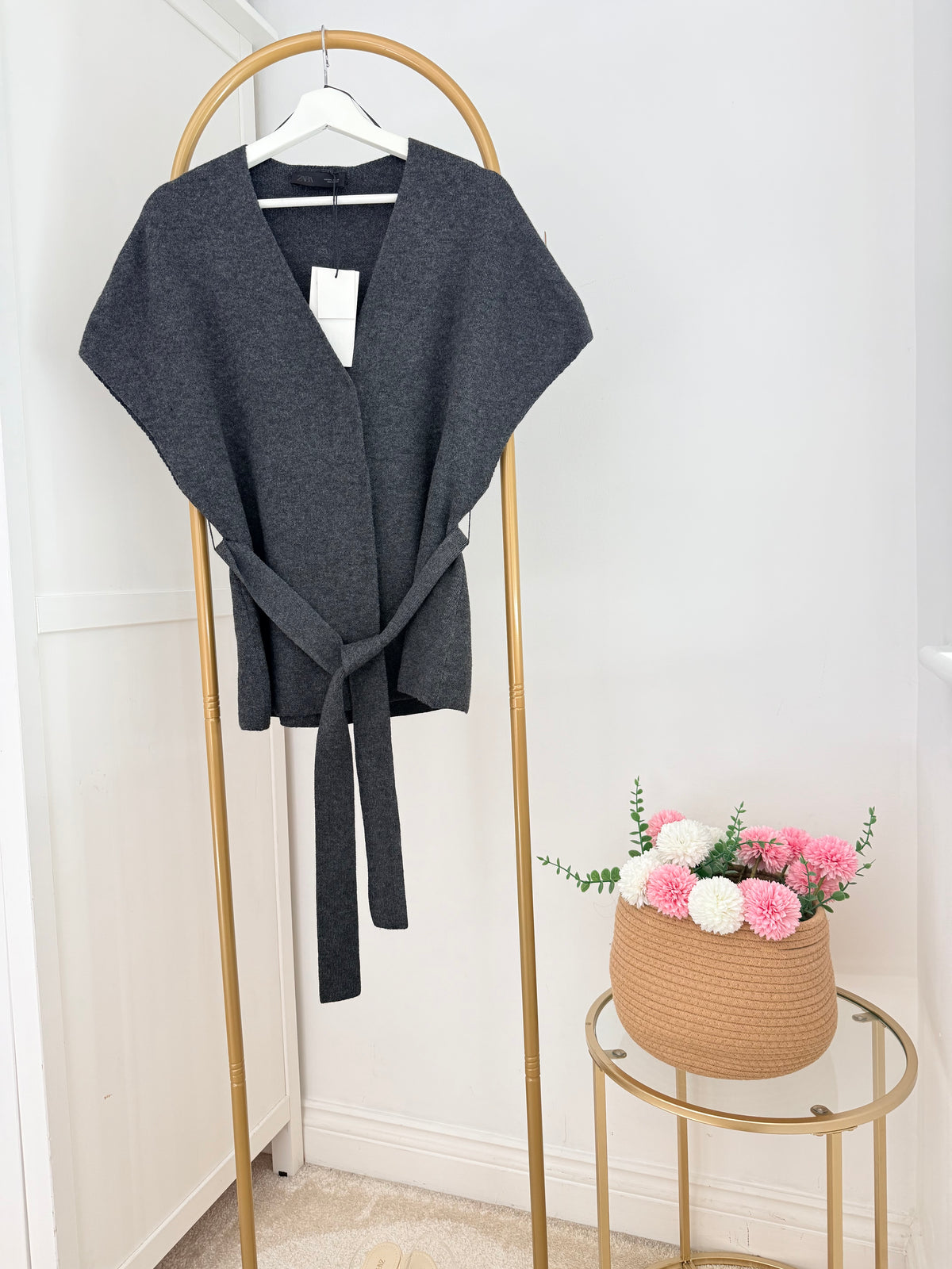     Front view of Zara grey knit belted waistcoat on hanger