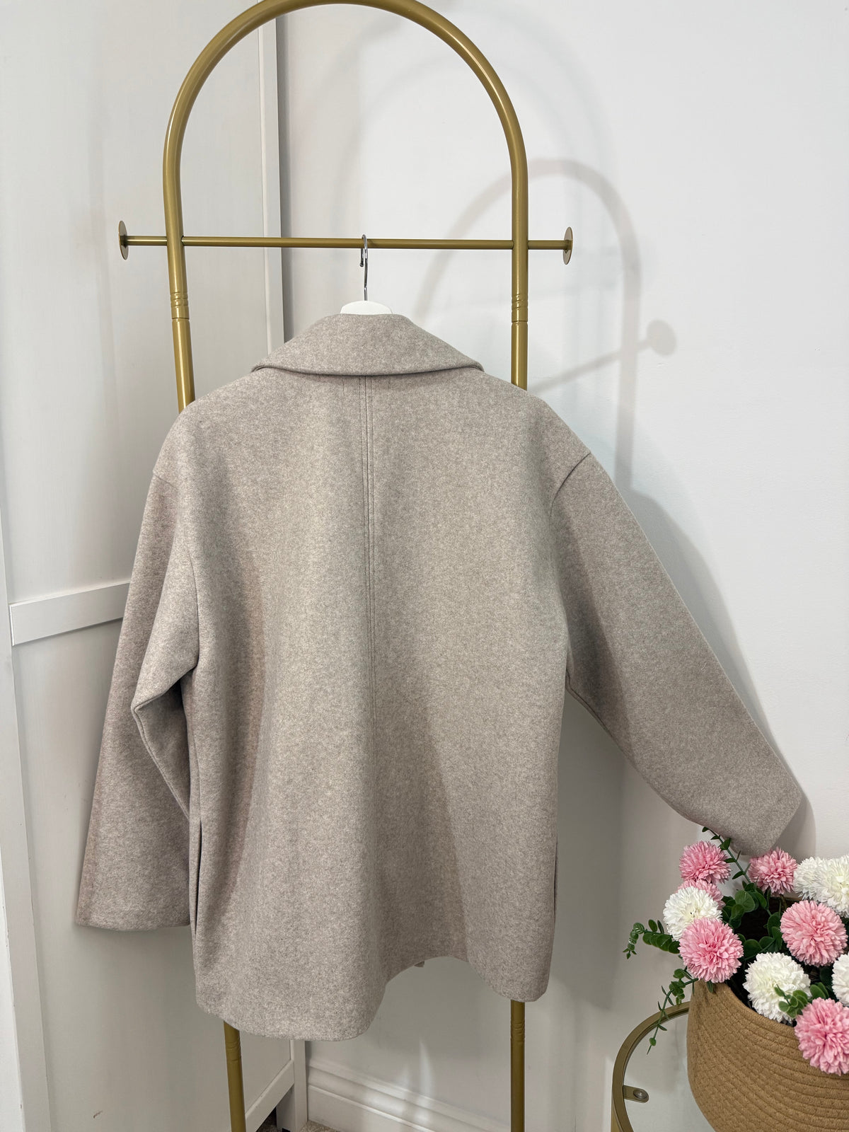     Back view of Zara beige oversized double breasted coat on hanger