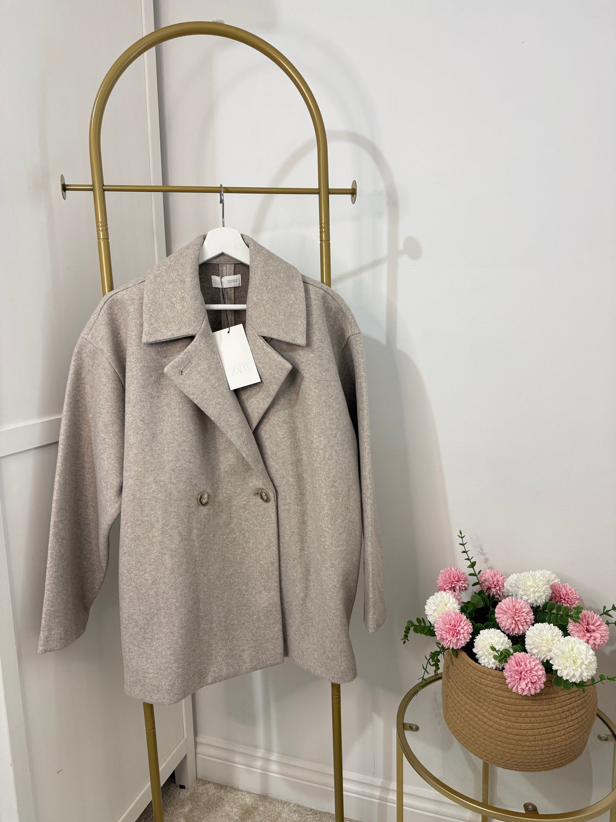     Front view of Zara beige oversized double breasted coat on hanger