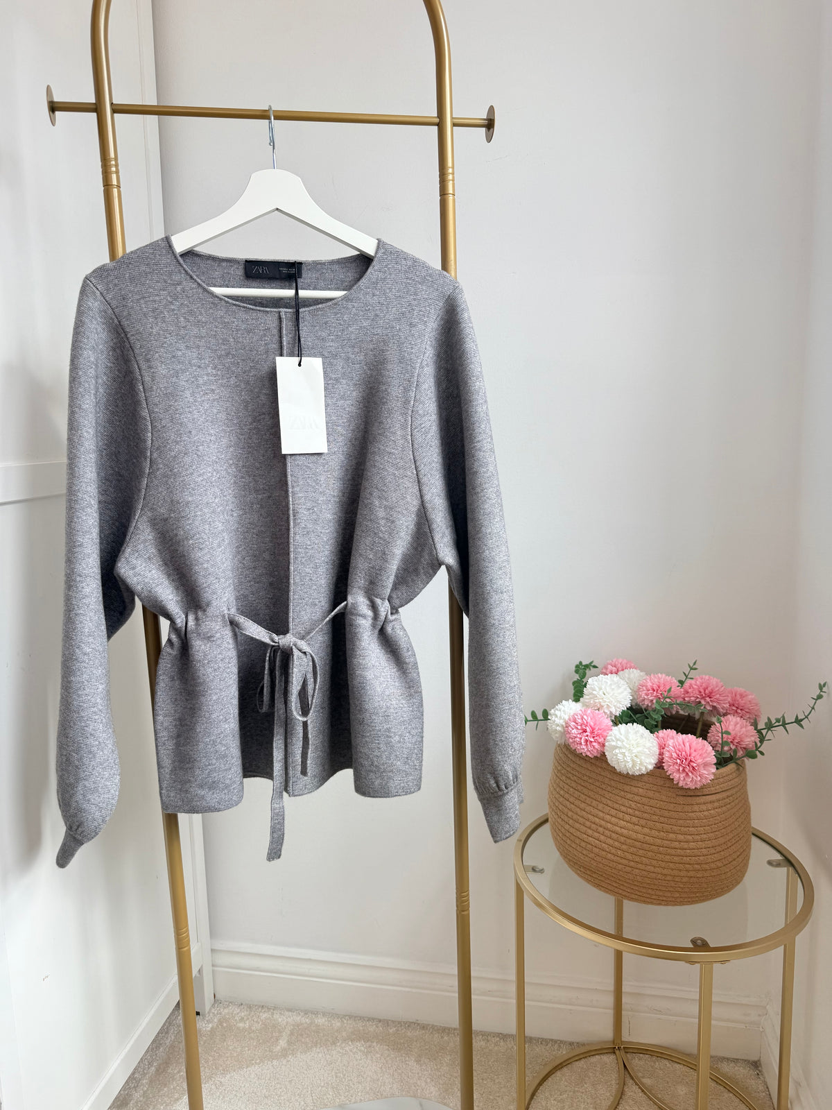     Front view of Zara grey belted knit jumper on hanger