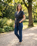     Woman wearing Zara grey knit belted waistcoat with jeans outdoors