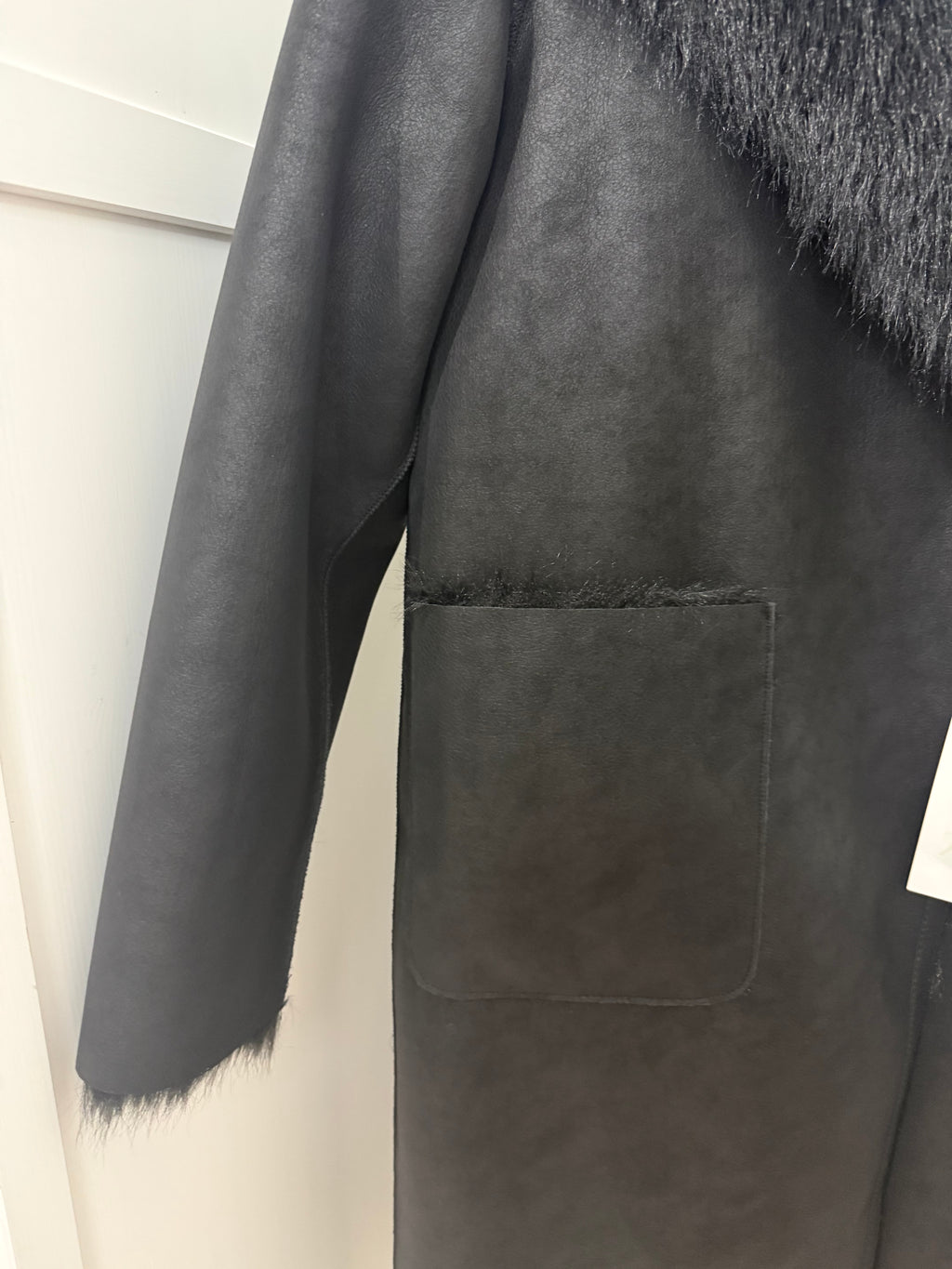     Close-up of Zara black reversible coat sleeve and pocket