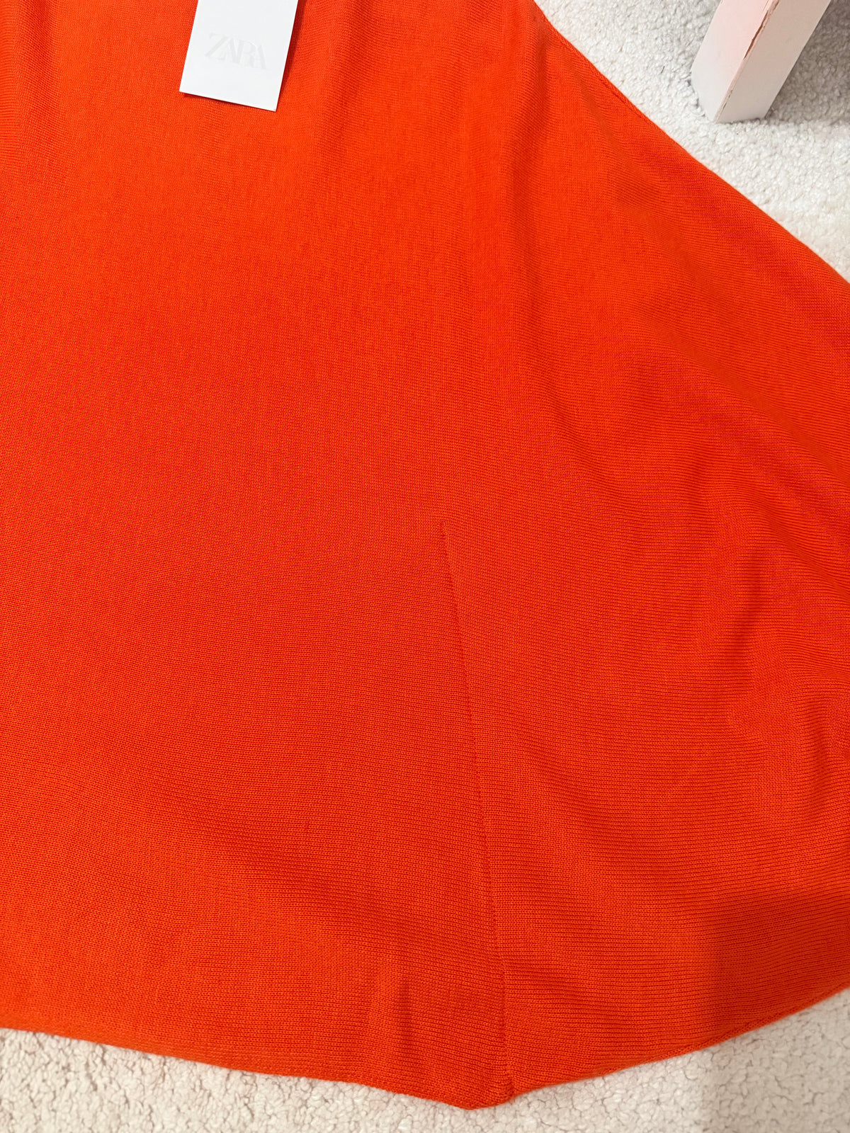     Close-up of Zara orange knit top fabric