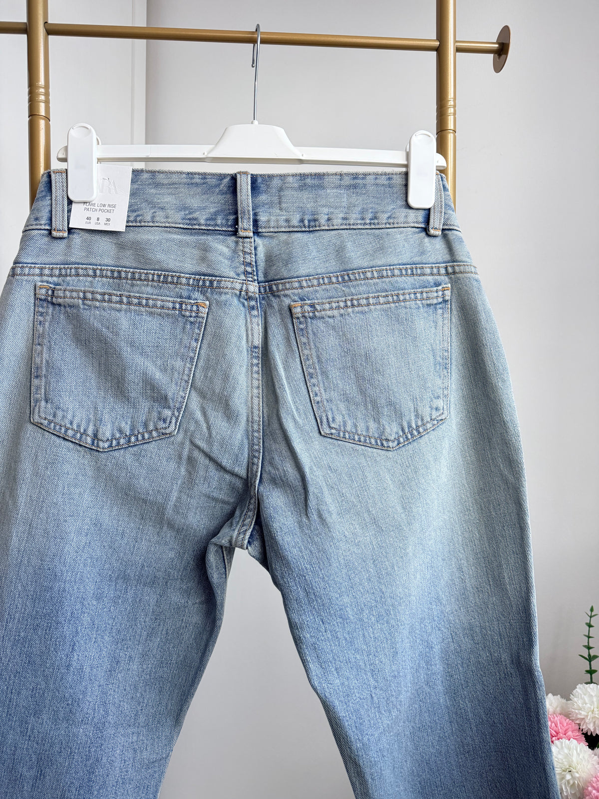     Back view of Zara blue low rise flared jeans