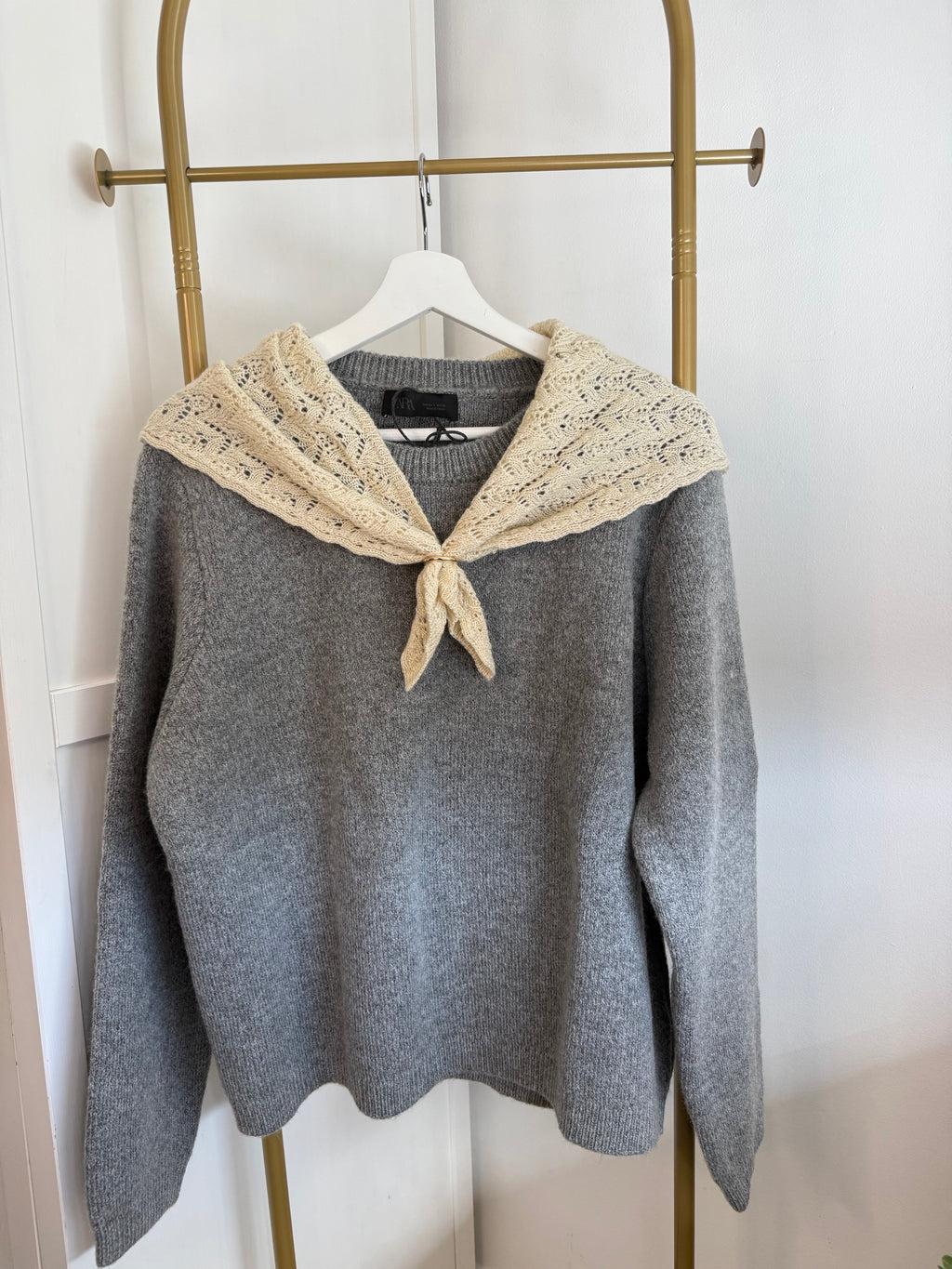     Front view of Zara grey knit sweater with contrast beige scarf
