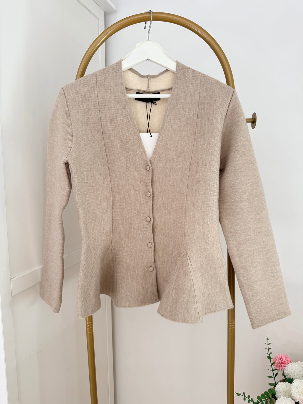     Close front view of Zara beige knit peplum cardigan