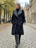     Woman wearing Zara black faux fur reversible coat on a city street