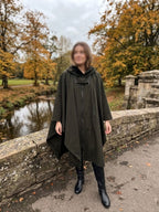     Woman wearing Zara khaki water repellent hooded cape rain coat outdoors